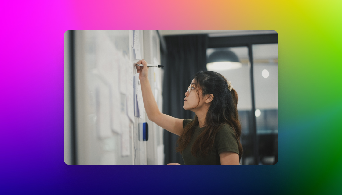 woman working on white board with gradient background